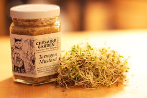 Jar of Cheshire Garden Garlic Mustard with small pile of sprouts